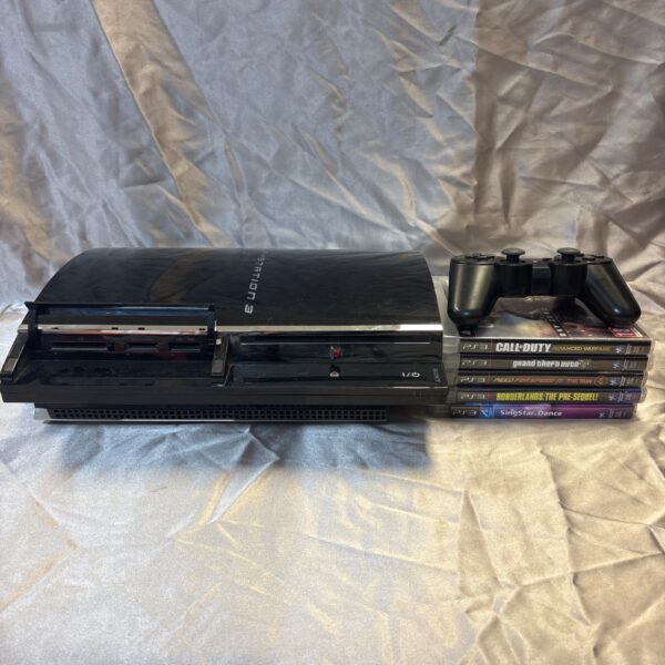 Front view of a Sony PlayStation 3 console with games.