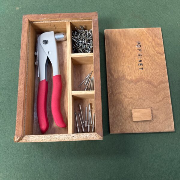 Vintage pop rivet gun set with assorted rivets in case.