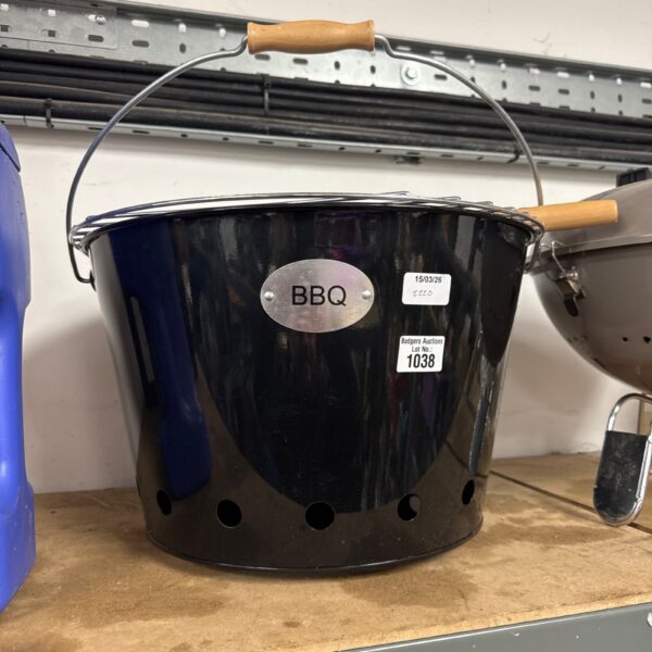 Vintage portable bucket BBQ grill for outdoor cooking.