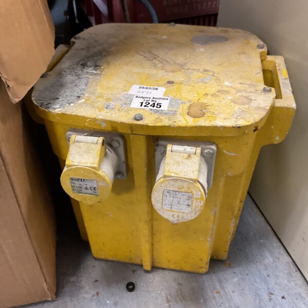 Yellow portable site transformer for construction power supply.