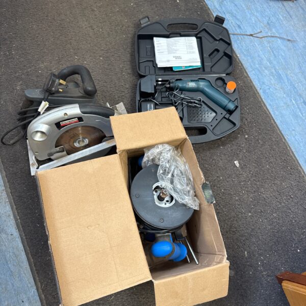 Power tool bundle including circular saw, drill and router for DIY projects.