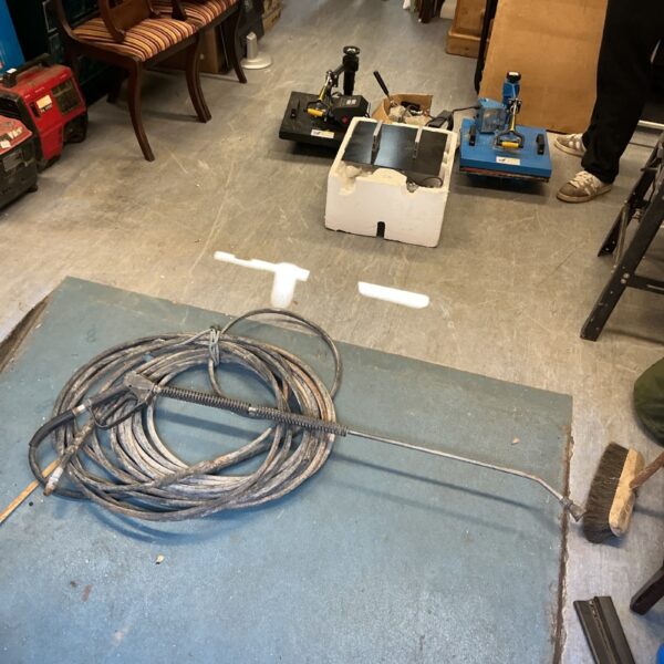 Long high-pressure washer hose with lance attachment.