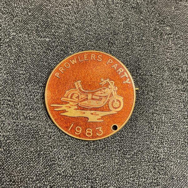 Front view of a 1983 Prowlers Party enamel pin badge.