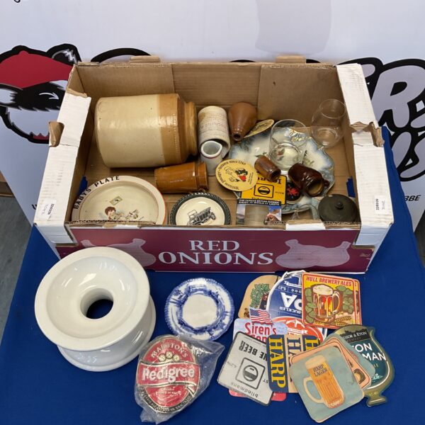 Vintage pub memorabilia collection featuring jars and a ham stand.