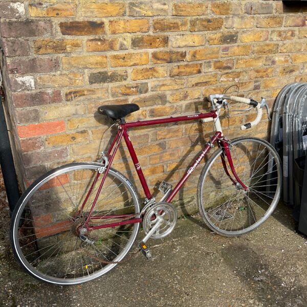 Vintage Raleigh Routier racer bike in red, side view.