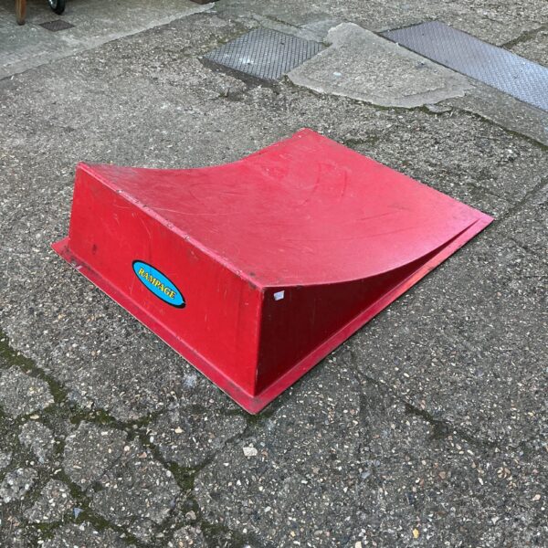 Red Rampage bike ramp for BMX and skate tricks.