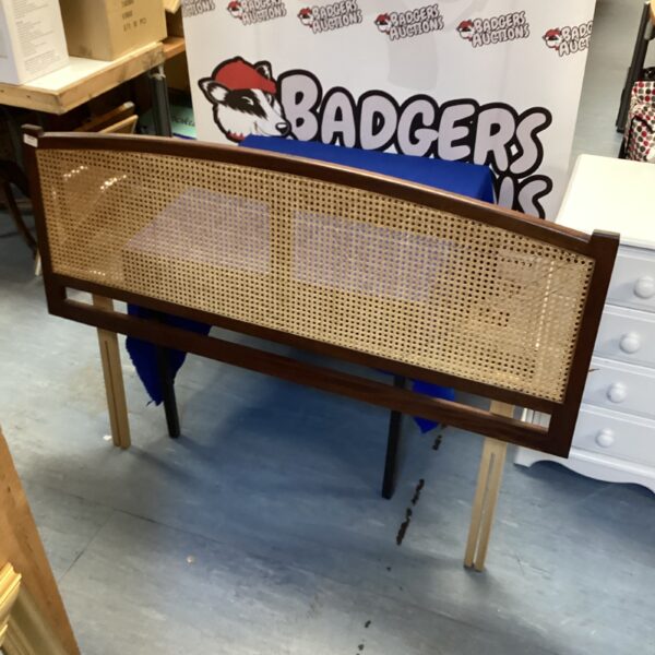 Vintage rattan double bed headboard with dark wood frame.