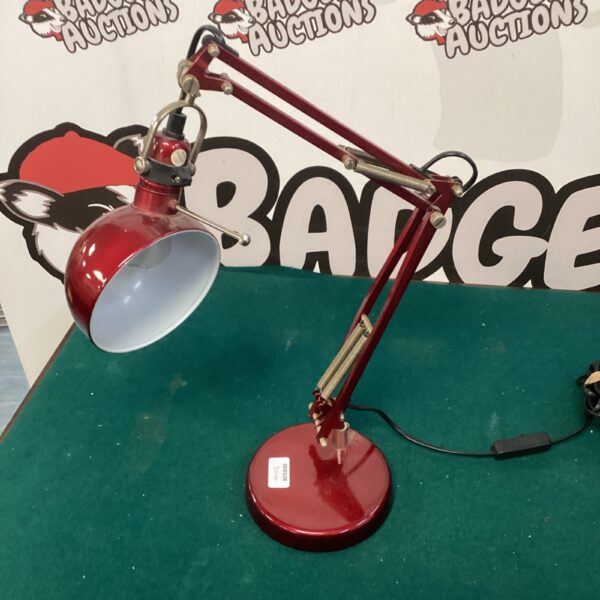 Vintage red Anglepoise desk lamp with adjustable arm.