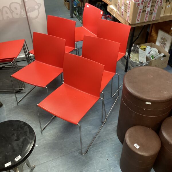 Set of six red chrome dining chairs with vintage style.