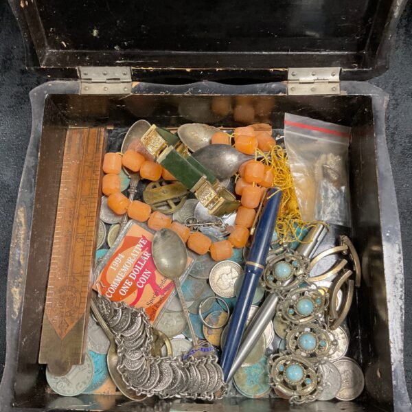 Vintage red lacquer box with a mixed lot of coins and curios inside.