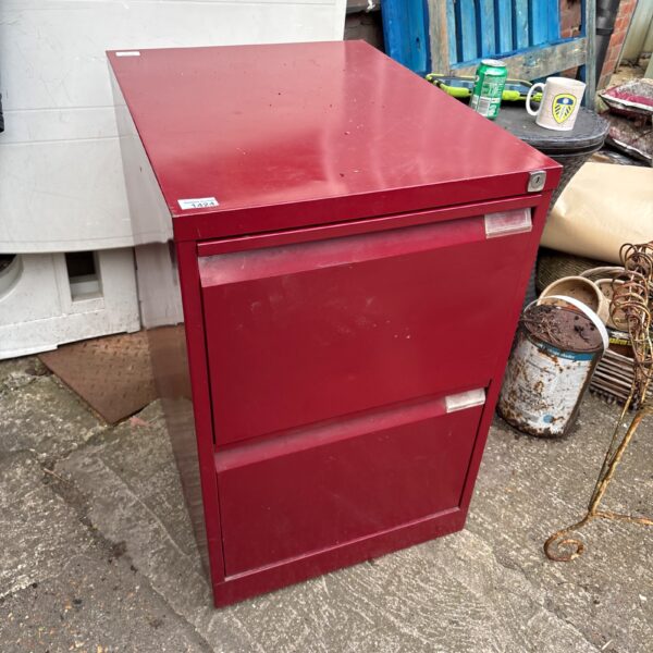 Red vintage metal filing cabinet for office storage.