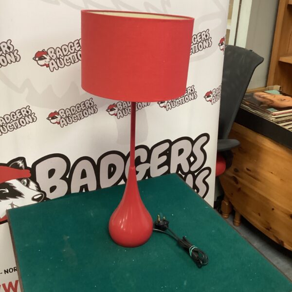 Vintage red teardrop lamp with a black base.
