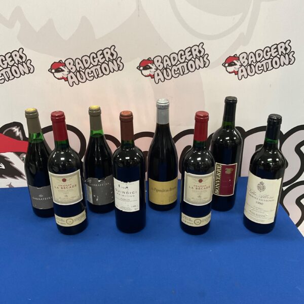Collection of red wine bottles including Chateau La Becade and Quindici.