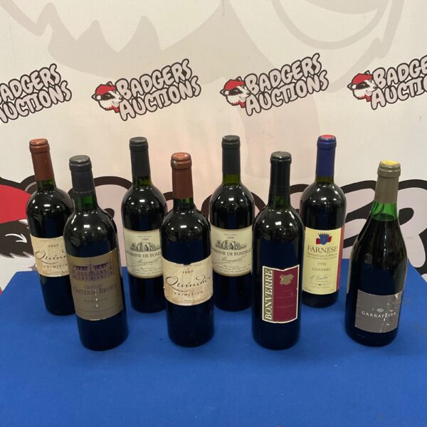 Collection of eight red wine bottles, including Domaine de Buadelle and Farnese.