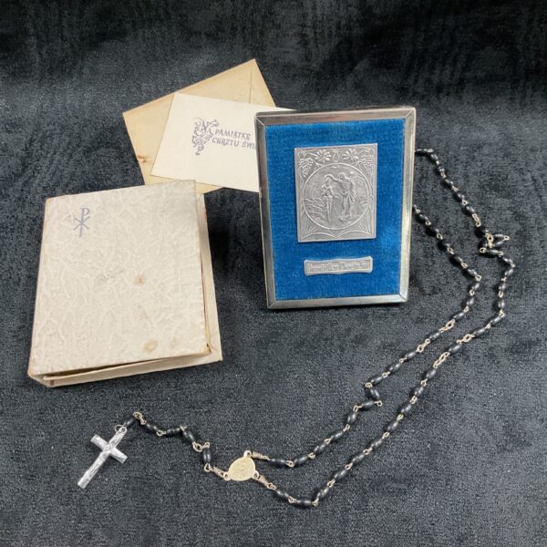 Vintage religious rosary beads and framed icon set for prayer.