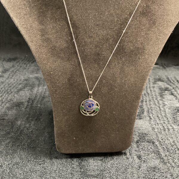 Silver Rennie Mackintosh pendant with enamel detailing on a chain.