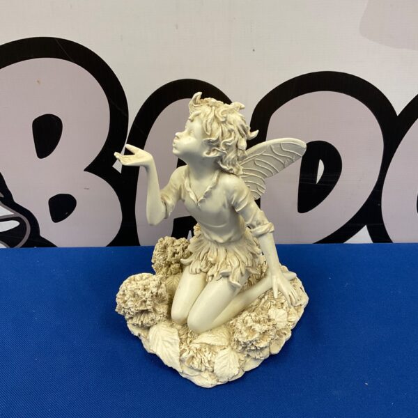 Detailed resin fairy sculpture with floral base.