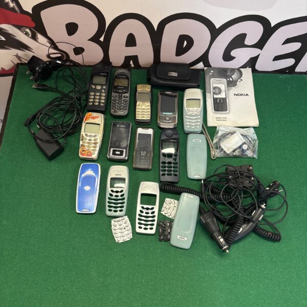 Vintage Nokia mobile phone lot with accessories displayed.