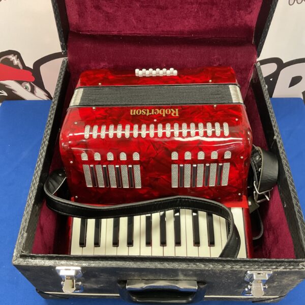 Vintage red Robertson accordion in a protective transit case.