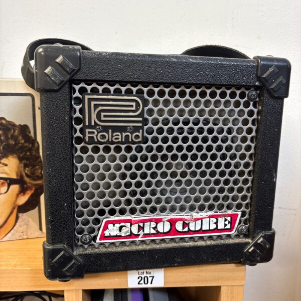 Black Roland Micro Cube guitar amplifier with silver grille.