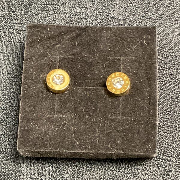 Elegant white stone Roman numeral stud earrings in gold plating.