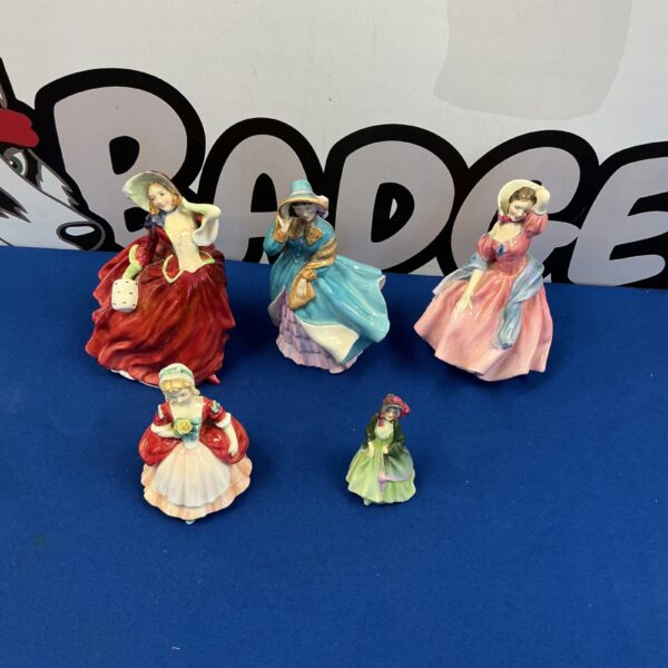 Vintage Royal Doulton figurine of a woman in traditional dress.