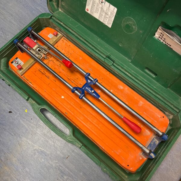 Rubi TS-60 manual tile cutter in open carrying case.