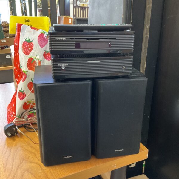 Black Sandstrom speakers and hifi system unit on a table.