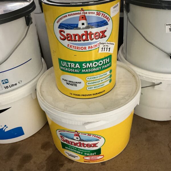 Two tubs of white Sandtex exterior masonry paint.