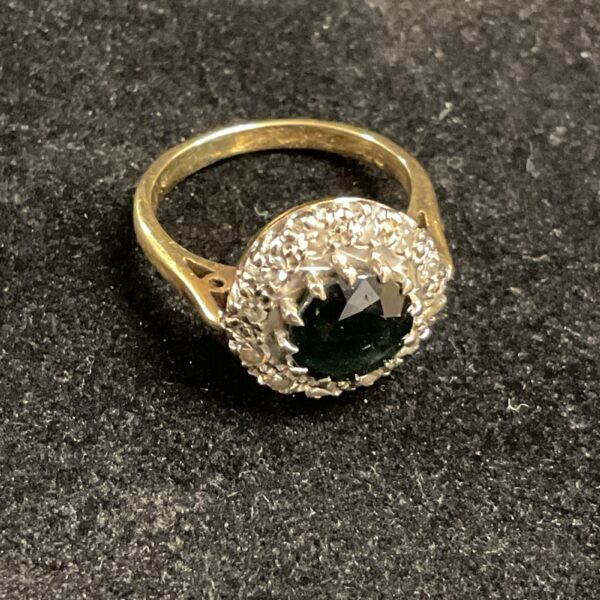 Close-up of a 14ct gold sapphire and diamond cluster ring.