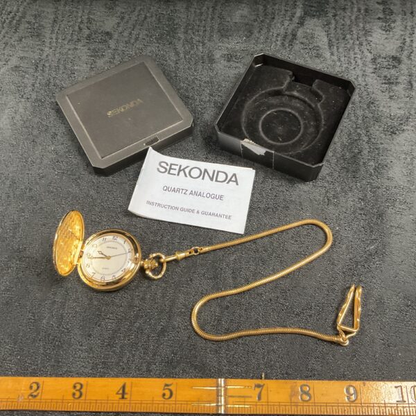 Gold Sekonda quartz pocket watch with chain displayed.