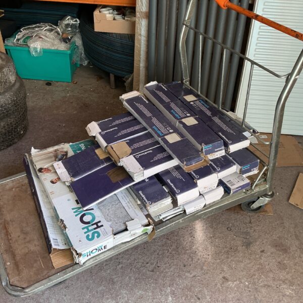 Stack of boxes containing self adhesive floor tiles for home renovation.