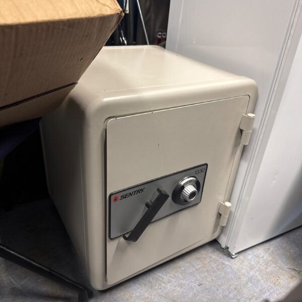 Used Sentry safe model 1400 with combination lock for secure storage.