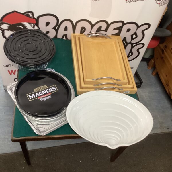 Collection of serving trays including wooden and tinfoil options.