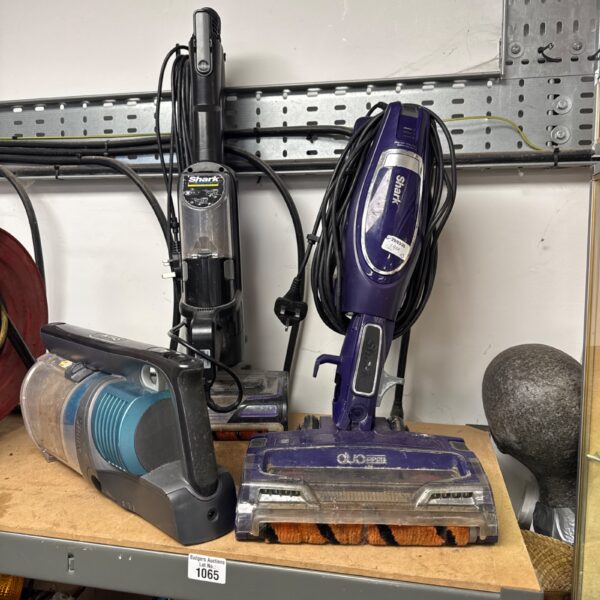 Selection of Shark hoovers and spare parts for cleaning.