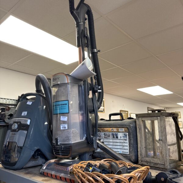 Shark upright vacuum cleaner with attachments and manual.