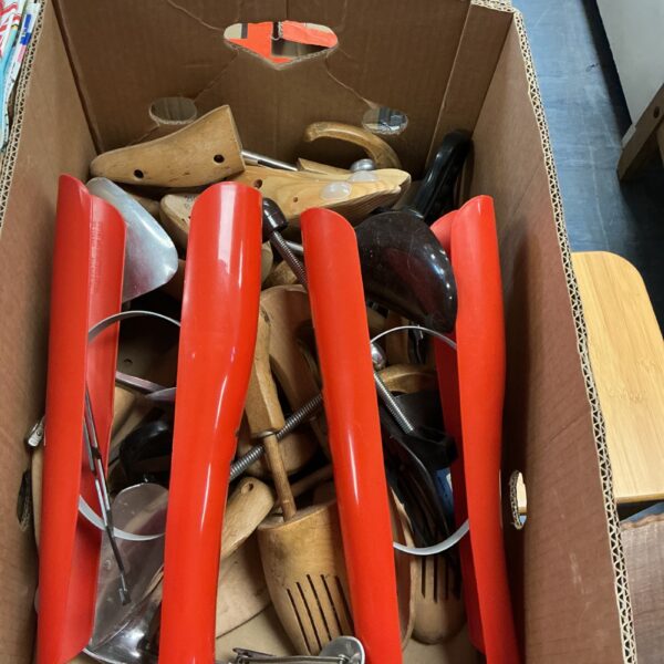 Vintage lot of wooden shoe stretchers and boot shapers for footwear care.