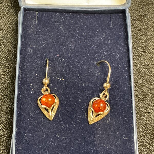 Vintage silver earrings with amber floral design.