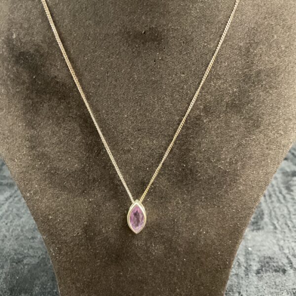 Silver amethyst pendant necklace on a delicate chain.