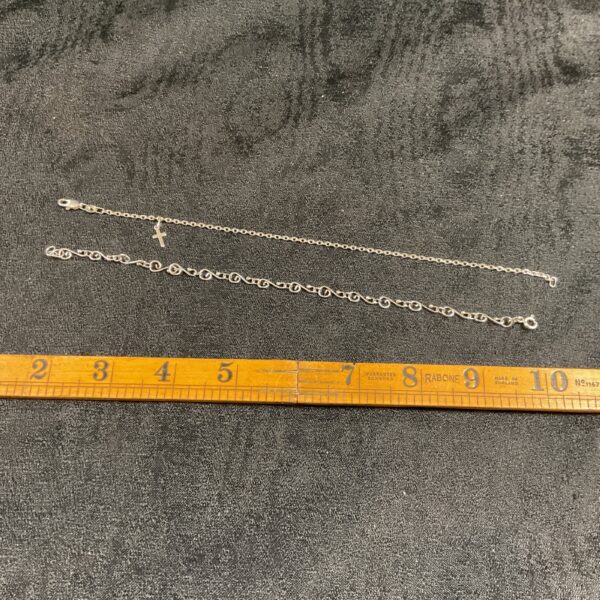 Pair of delicate 925 silver anklet bracelets on a neutral background.