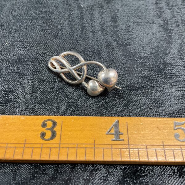 Vintage silver Art Nouveau brooch with delicate floral details.