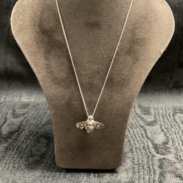 Delicate silver bee pendant on a chain, detailed insect jewellery.