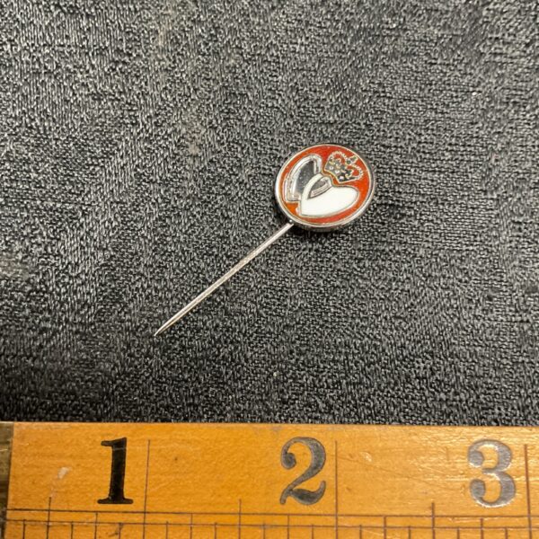 Vintage silver blood donor pin with red enamel detail.