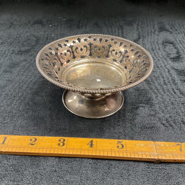 Ornate silver bon bon dish with pierced design, antique collectible.