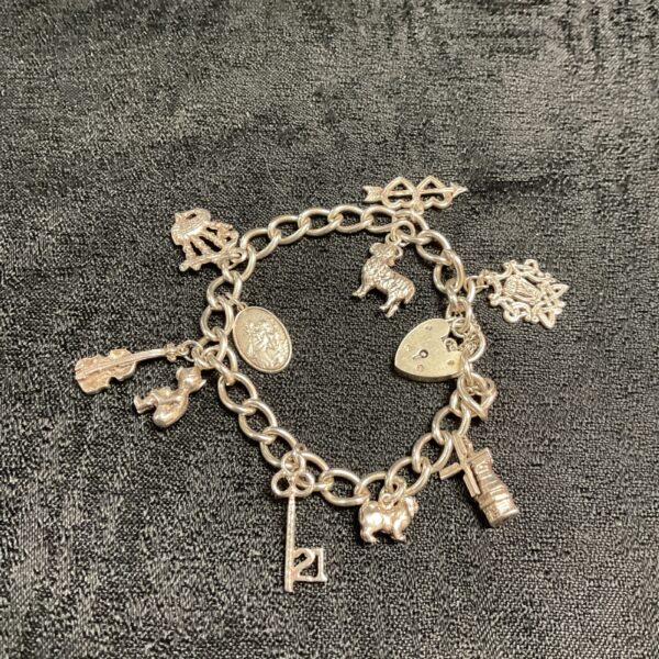Vintage silver charm bracelet with detailed charms.