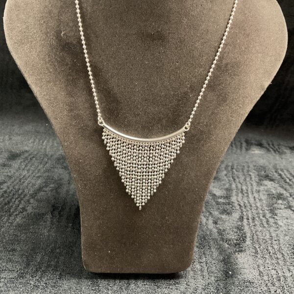 Close-up of a vintage sterling silver drop ball necklace.