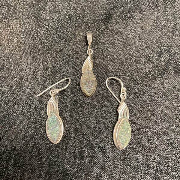 Silver drop earrings and pendant with green stone.
