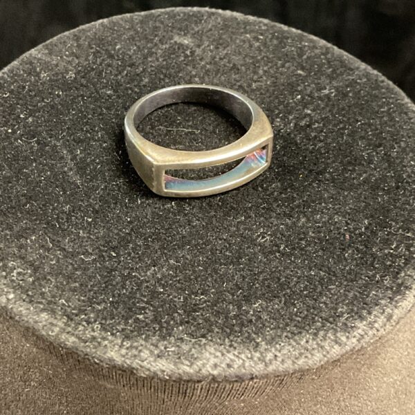 Silver open ring with iridescent stone detail.