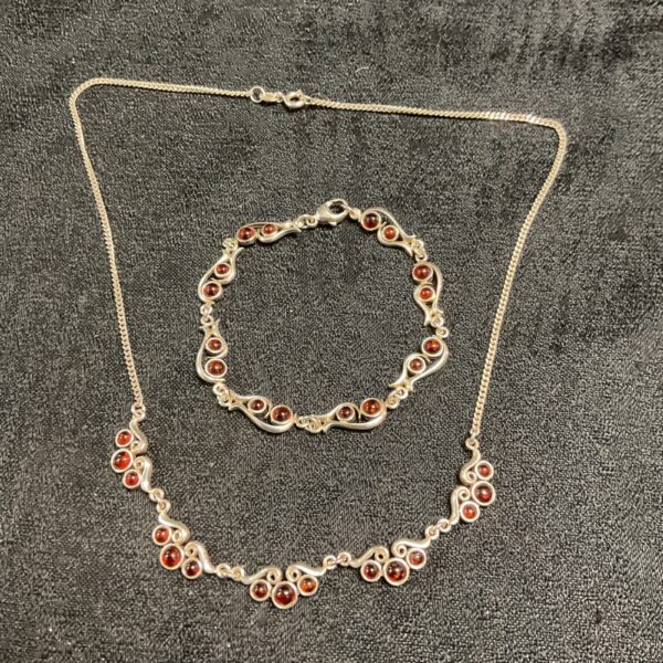 925 silver necklace and bracelet set with red stones.