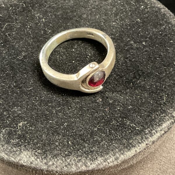Silver ring with a vibrant red stone, size Q.